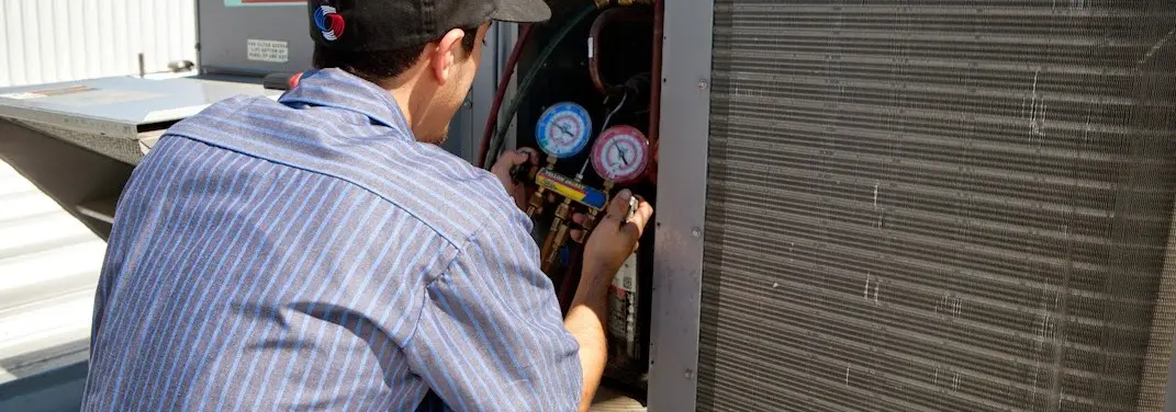 HVAC technician servicing a condenser unit in Fort Myers